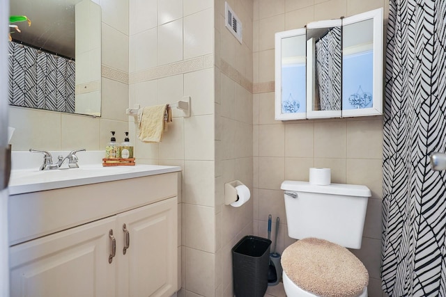 4306 La Mora Ct, Tampa, FL 33611 - full bathroom featuring tasteful backsplash, visible vents, toilet, tile walls, and vanity