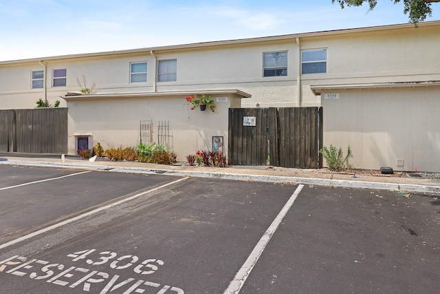 4306 La Mora Ct, Tampa, FL 33611 - uncovered parking lot featuring fence