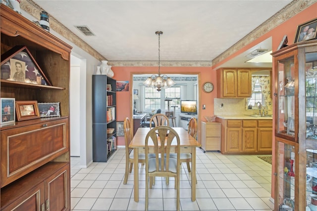 dining area with light tile patterned floors, an inviting chandelier, visible vents, and a wealth of natural light