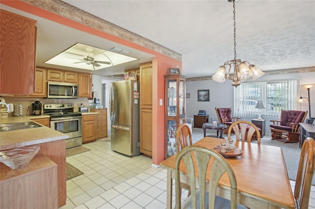 dining room with light tile patterned floors, visible vents, and ceiling fan with notable chandelier