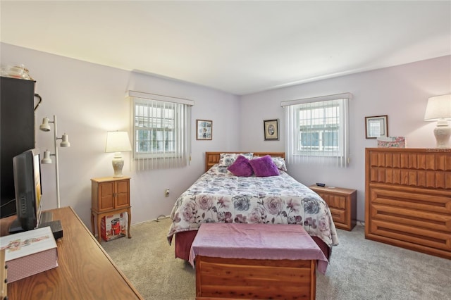 bedroom featuring light carpet