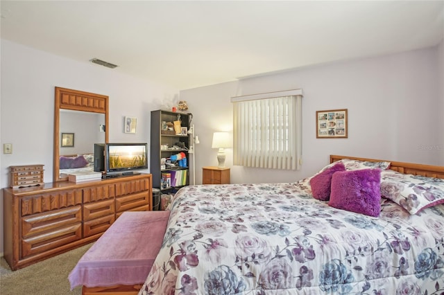 carpeted bedroom featuring visible vents