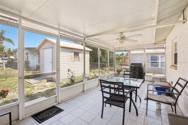 sunroom / solarium featuring a ceiling fan, outdoor dining space, and visible vents