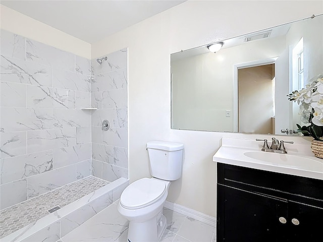 bathroom with visible vents, baseboards, toilet, marble finish floor, and tiled shower