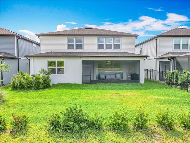 17683 Ramble On Way, Land O Lakes, FL 34638 - rear view of property featuring a sunroom, a lawn, fence, and roof with shingles