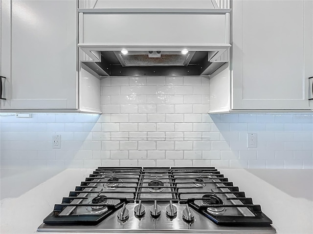 17683 Ramble On Way, Land O Lakes, FL 34638 - kitchen with decorative backsplash, stainless steel gas cooktop, custom exhaust hood, and a tray ceiling