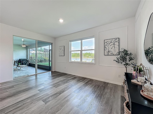 17683 Ramble On Way, Land O Lakes, FL 34638 - interior space featuring a healthy amount of sunlight, baseboards, ceiling fan, and dark wood finished floors