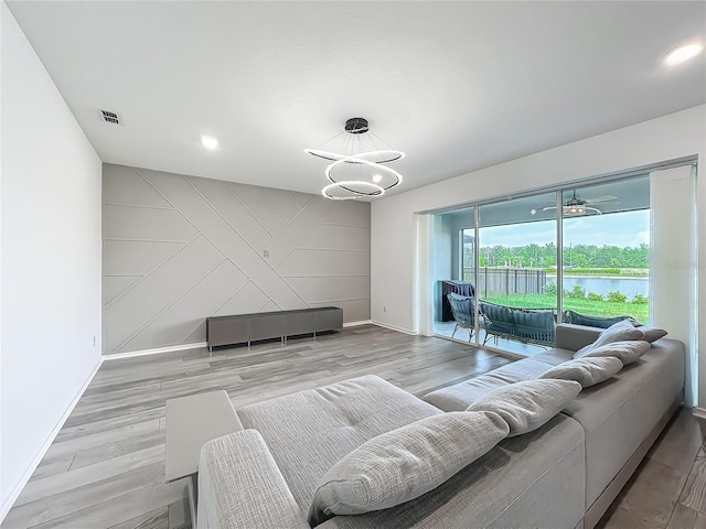 17683 Ramble On Way, Land O Lakes, FL 34638 - living area featuring visible vents, baseboards, a water view, a chandelier, and light wood finished floors