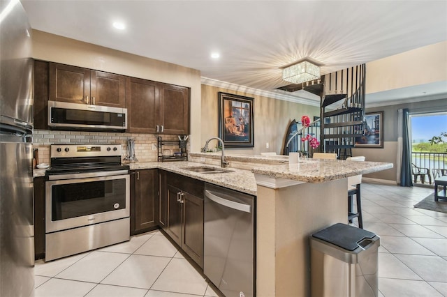 2400 Feather Sound Dr Unit 735, Clearwater, FL 33762 - kitchen featuring stainless steel appliances, light tile patterned floors, a sink, and dark brown cabinets