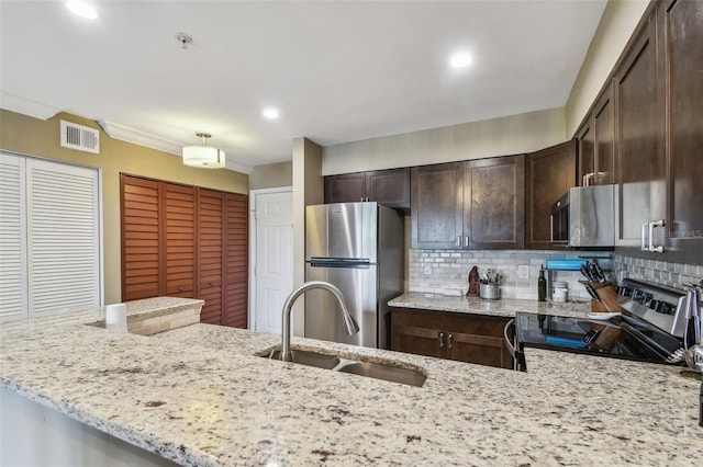 2400 Feather Sound Dr Unit 735, Clearwater, FL 33762 - kitchen with dark brown cabinetry, a sink, stainless steel appliances, decorative backsplash, and visible vents