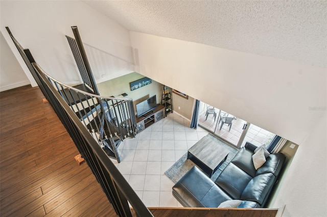 2400 Feather Sound Dr Unit 735, Clearwater, FL 33762 - interior space featuring baseboards, vaulted ceiling, a textured ceiling, and wood finished floors