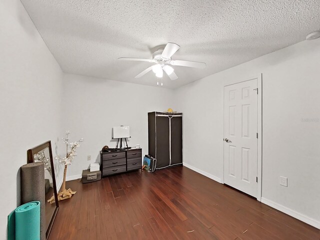 2400 Feather Sound Dr Unit 735, Clearwater, FL 33762 - interior space featuring a textured ceiling, ceiling fan, dark wood finished floors, and baseboards