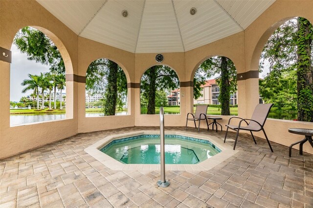 2400 Feather Sound Dr Unit 735, Clearwater, FL 33762 - view of swimming pool with a patio and a water view