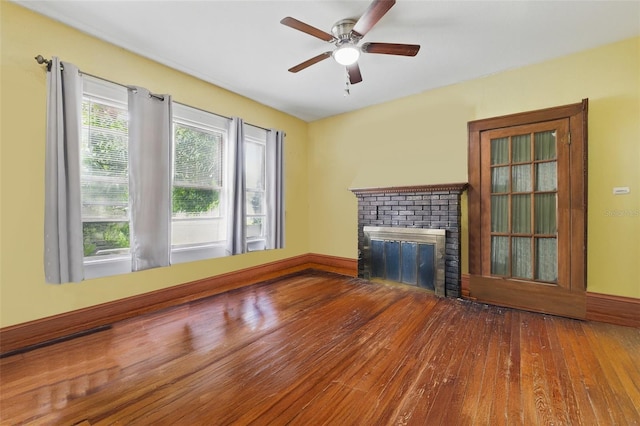 4100 1st Ave S, Saint Petersburg, FL 33711 - unfurnished living room featuring a ceiling fan, hardwood / wood-style floors, and a fireplace
