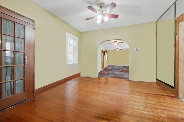 4100 1st Ave S, Saint Petersburg, FL 33711 - spare room featuring ceiling fan, arched walkways, and wood finished floors