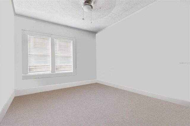 4100 1st Ave S, Saint Petersburg, FL 33711 - empty room with a ceiling fan, a textured ceiling, baseboards, carpet flooring, and crown molding