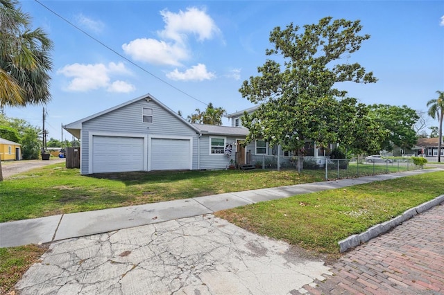 4100 1st Ave S, Saint Petersburg, FL 33711 - view of front of home featuring a front lawn, fence, a garage, and aphalt driveway
