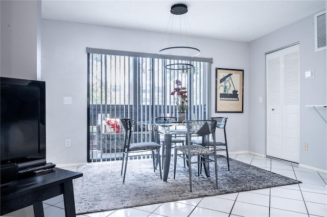 dining space with visible vents, plenty of natural light, tile patterned flooring, and baseboards