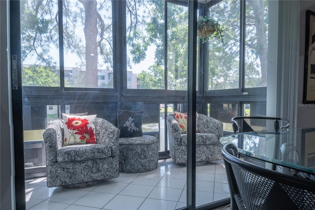 sunroom featuring tile patterned flooring and a healthy amount of sunlight
