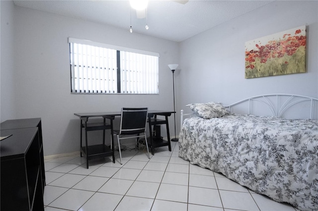 bedroom with light tile patterned flooring, ceiling fan, and baseboards