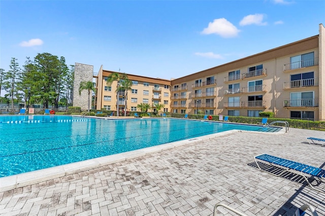 pool featuring a patio and fence