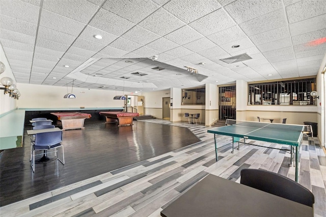 recreation room featuring a paneled ceiling, visible vents, billiards, and wood finished floors