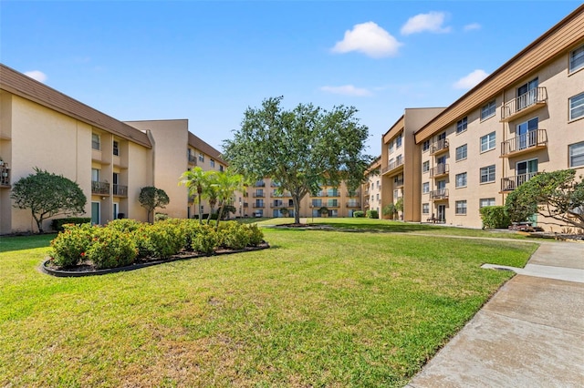 view of home's community featuring a yard and a residential view