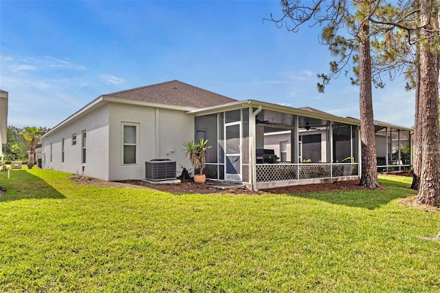 23935 Coral Ridge Ln, Land O Lakes, FL 34639 - rear view of house featuring a sunroom, a yard, stucco siding, and central air condition unit