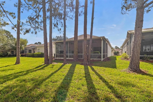 23935 Coral Ridge Ln, Land O Lakes, FL 34639 - back of house with a sunroom and a lawn