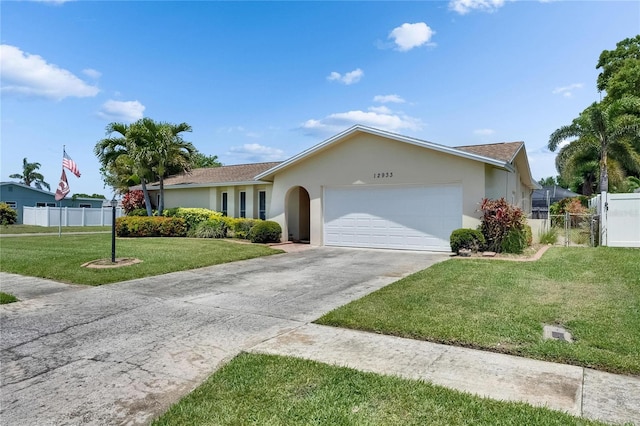 ranch-style house featuring stucco siding, fence, driveway, and a garage