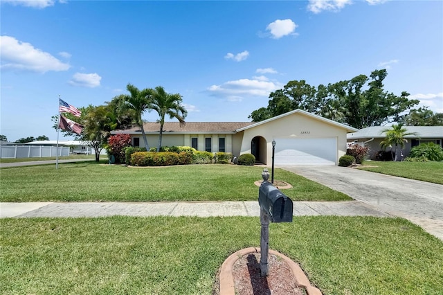 ranch-style house with a garage, a front lawn, driveway, and stucco siding