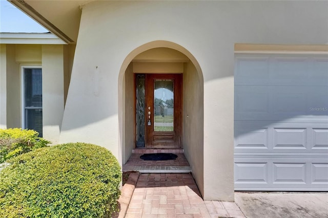 entrance to property featuring stucco siding