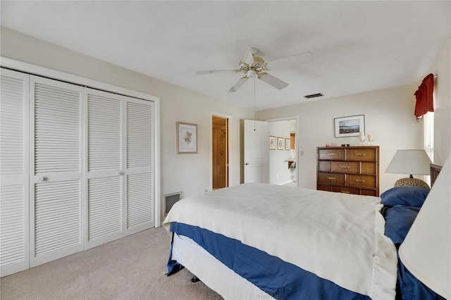 bedroom with visible vents, ceiling fan, carpet flooring, and a closet