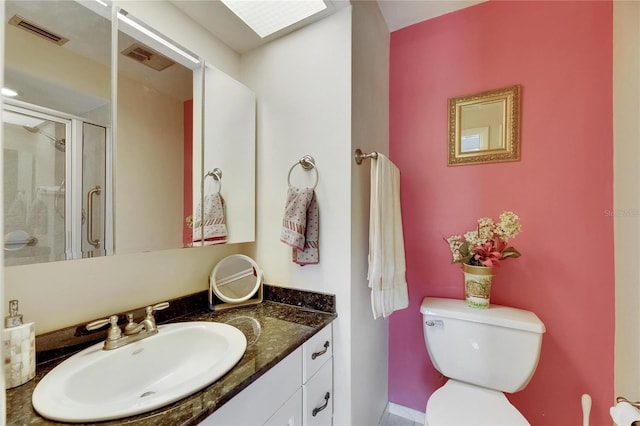 bathroom with toilet, a stall shower, visible vents, and vanity