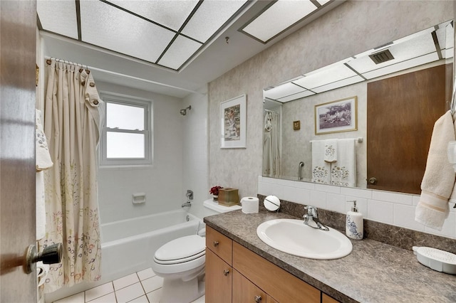 bathroom with tile patterned floors, shower / tub combo, toilet, and vanity