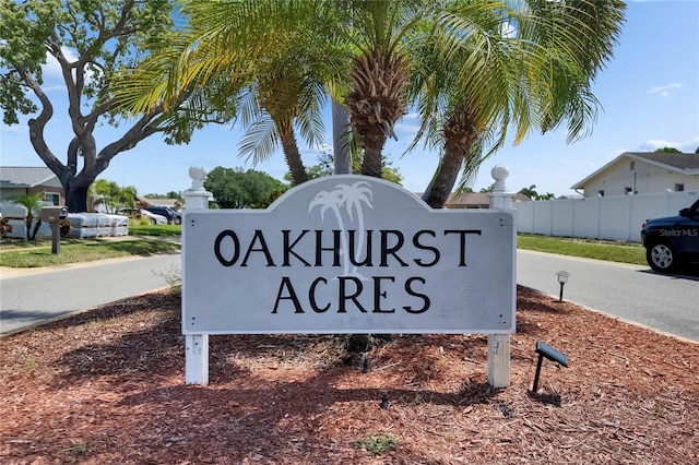 community / neighborhood sign featuring fence