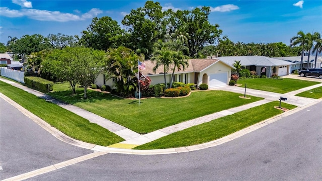 ranch-style house featuring a front lawn, driveway, and a garage