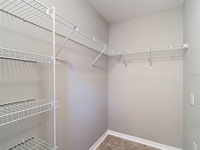 walk in closet with tile patterned flooring