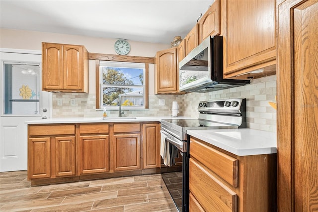 2134 6th Ave N, Saint Petersburg, FL 33713 - kitchen with light countertops, a sink, decorative backsplash, and stainless steel appliances