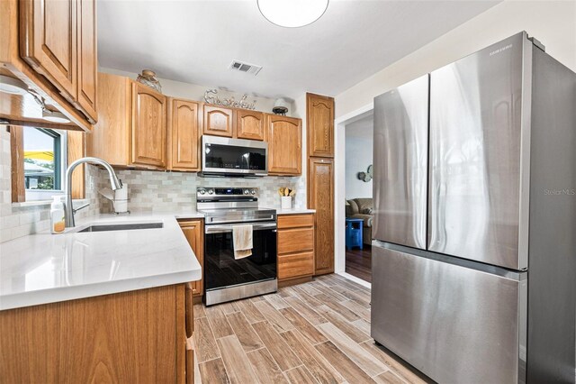 2134 6th Ave N, Saint Petersburg, FL 33713 - kitchen with a sink, appliances with stainless steel finishes, tasteful backsplash, and visible vents