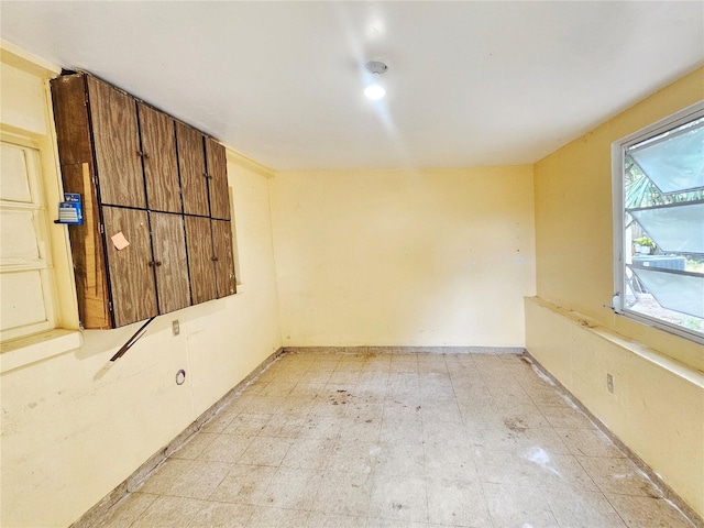 spare room featuring baseboards