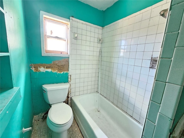 bathroom featuring toilet, tile patterned flooring, and tile walls