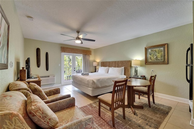 1420 Bayshore Blvd Unit 409, Dunedin, FL 34698 - bedroom with access to exterior, light tile patterned flooring, a textured ceiling, french doors, and a textured wall