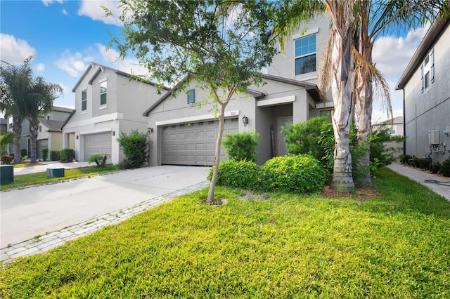 9617 Channing Hill Dr, Ruskin, FL 33573 - view of front of house with concrete driveway, a front yard, and stucco siding