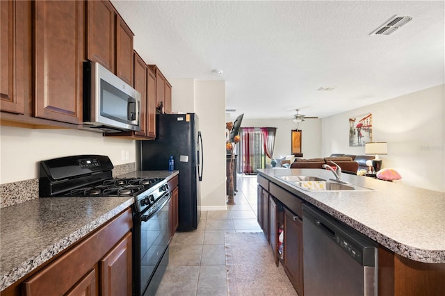 9617 Channing Hill Dr, Ruskin, FL 33573 - kitchen with a kitchen island with sink, black appliances, a sink, visible vents, and open floor plan