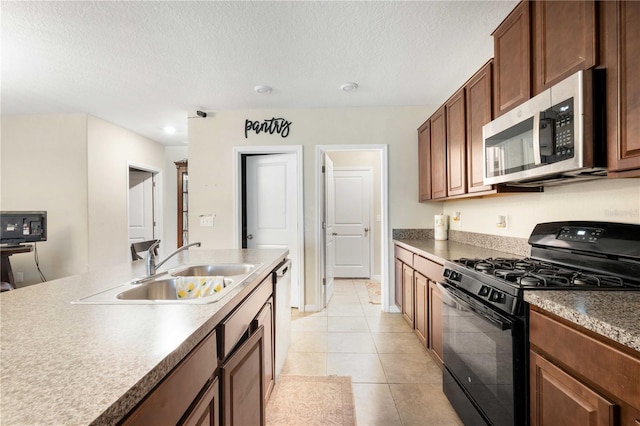 9617 Channing Hill Dr, Ruskin, FL 33573 - kitchen featuring light tile patterned flooring, a textured ceiling, a sink, and stainless steel appliances