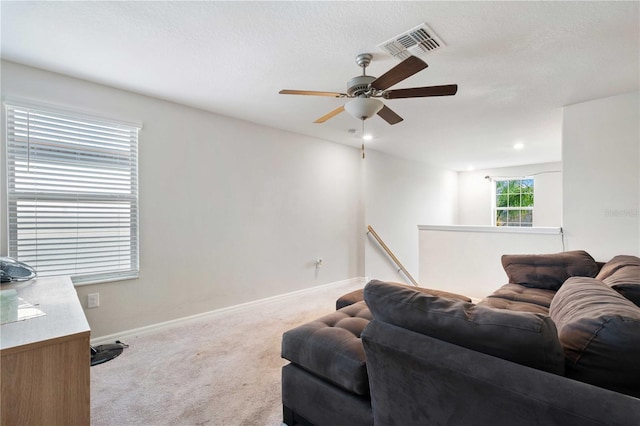 9617 Channing Hill Dr, Ruskin, FL 33573 - living area featuring visible vents, ceiling fan, baseboards, and carpet floors
