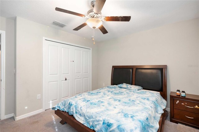 9617 Channing Hill Dr, Ruskin, FL 33573 - bedroom featuring visible vents, ceiling fan, baseboards, a closet, and light carpet