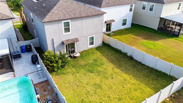 9617 Channing Hill Dr, Ruskin, FL 33573 - exterior space featuring a patio, roof with shingles, stucco siding, central AC unit, and a fenced backyard