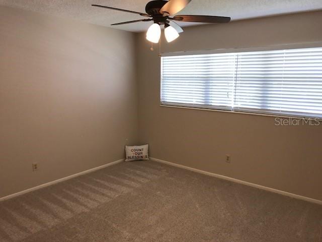 2450 Canadian Way Unit 6, Clearwater, FL 33763 - carpeted empty room featuring a ceiling fan and baseboards